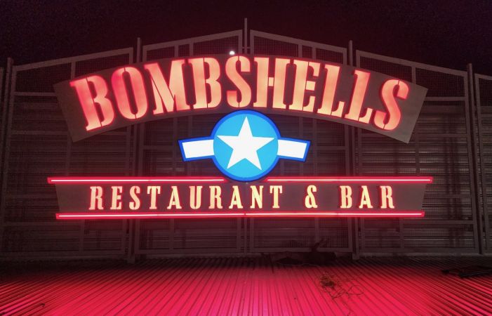 lighted exterior sign for Bombshells Restaurant & Bar