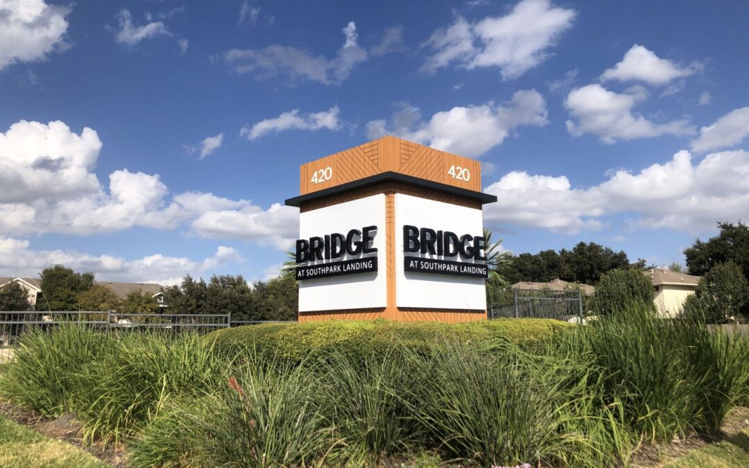 a large monument sign for Bridge at Southpark Landing apartments