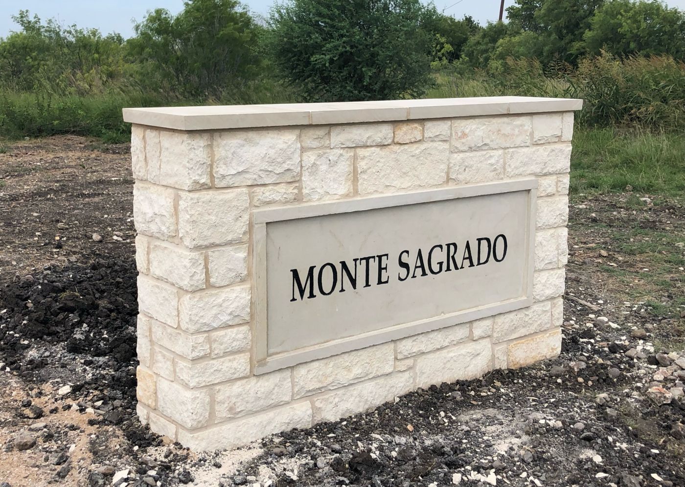 a simple monument neighborhood entrance sign for Monte Sagrado near Austin, TX
